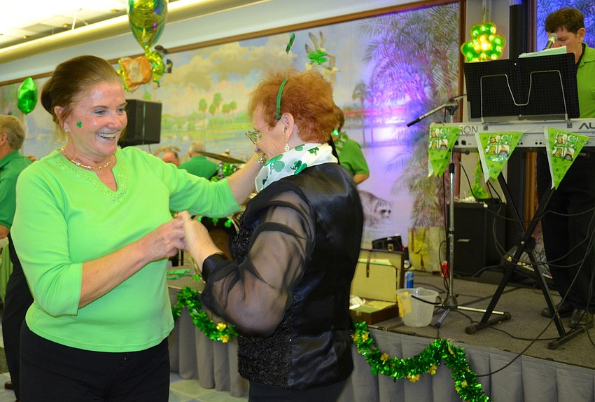 Maggie Urban laughs as she dances with her sister, Marie Halpin.