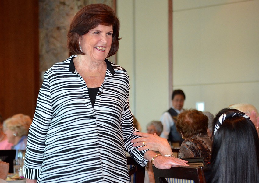 Pat McGouran laughs as she walks around the room in her first outfit.