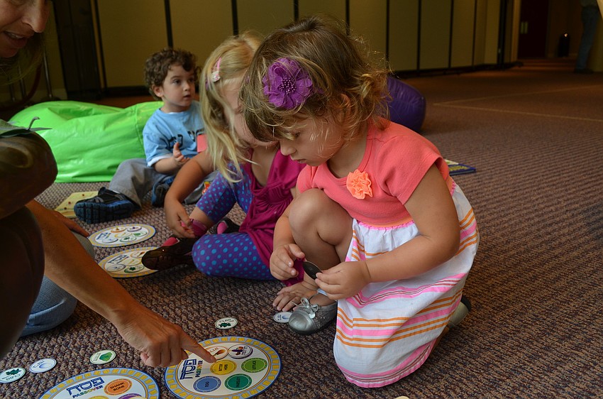 Cora Traina plays with a puzzle.