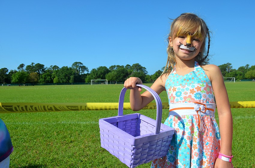 Isabela Bennett gets ready to fill her basket with candy.