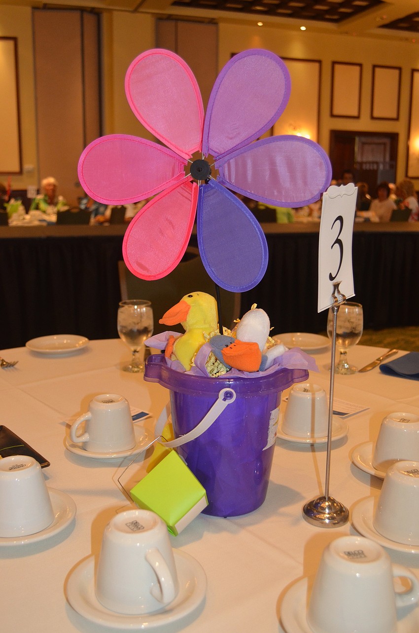 Bright flowers and stuffed animals adorn each table.