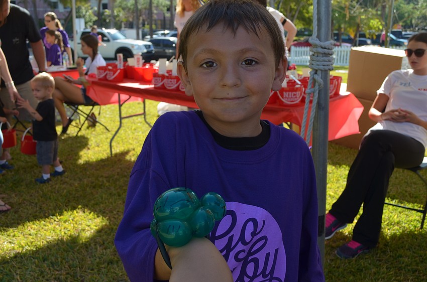 Isaiah Staring with a balloon turtle bracelet.