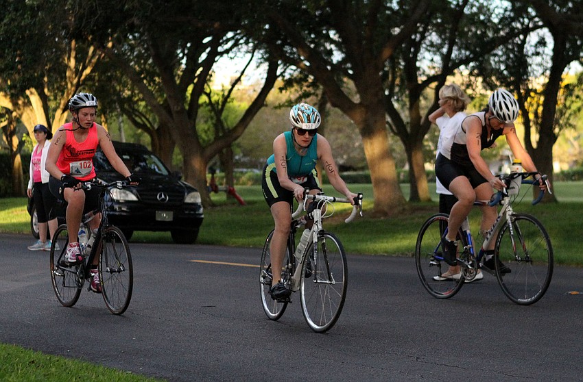 Emma Jones, No. 102, Joann Kakascik-Dye, No. 107, and Jessica Boson, No. 21, all head off on their bikes.