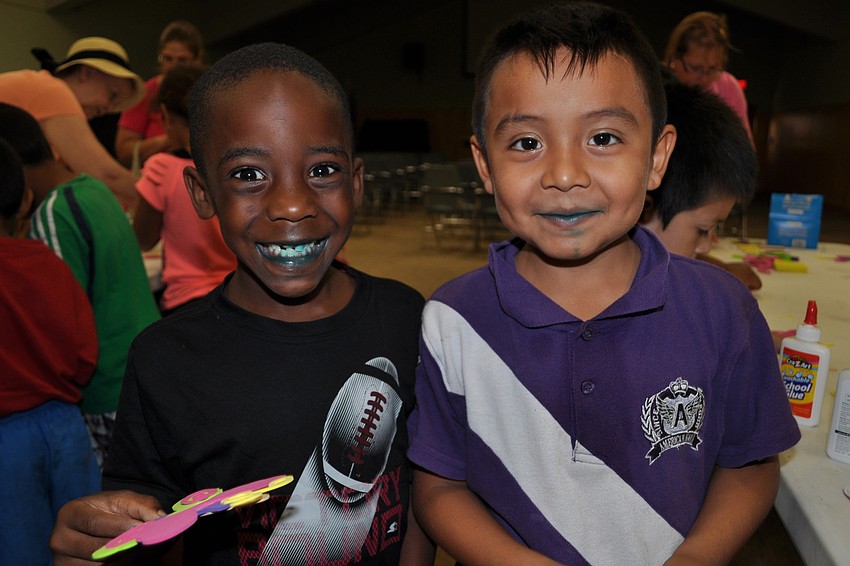 Jayden Dundar, 5, and Omar Regalodo, 5, make a butterfly during craft time.