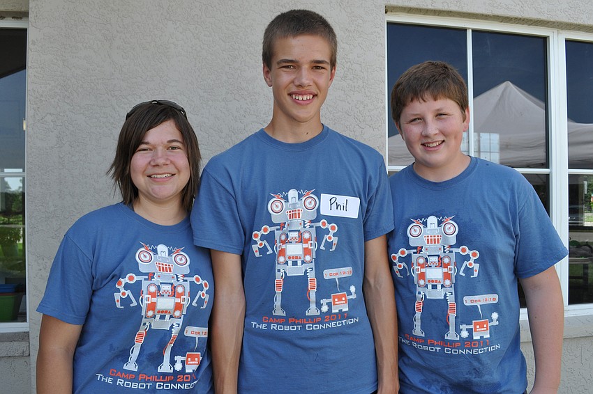Danae Witte volunteers with Phil Balge and Sam Boeder, who were visiting from Minnesota.