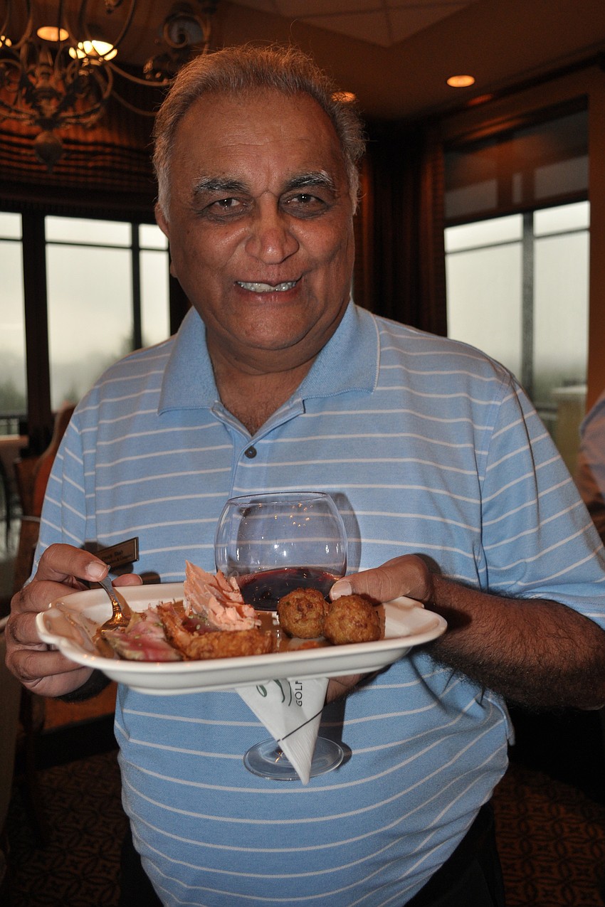 Chuck Shah, of Michael Saunders, enjoys a plate of seafood.