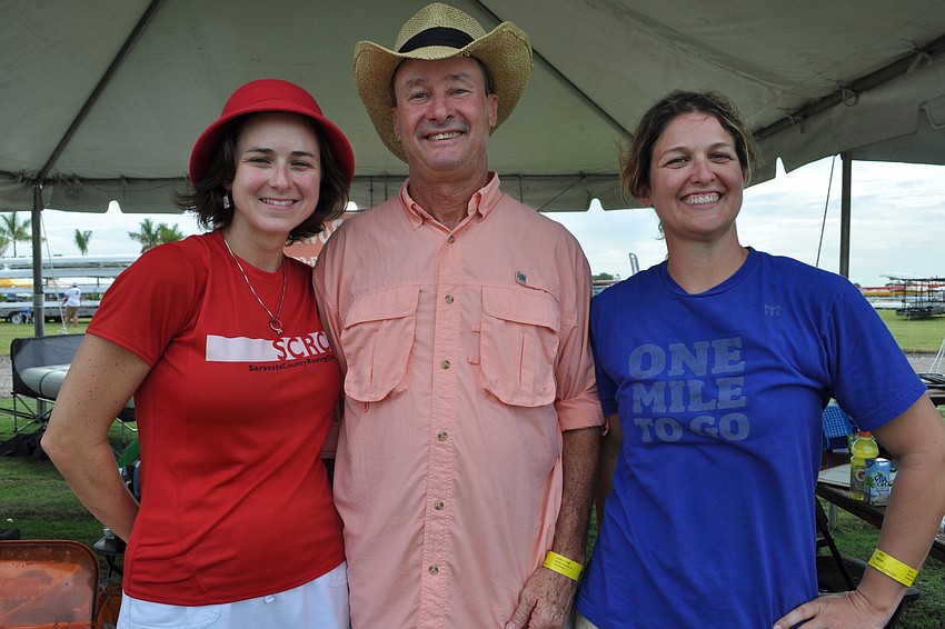 Casey McKenna-Monroe, Vinson Barefoot and Holly Weber watch fellow rowers from the Sarasota Rowing Club.