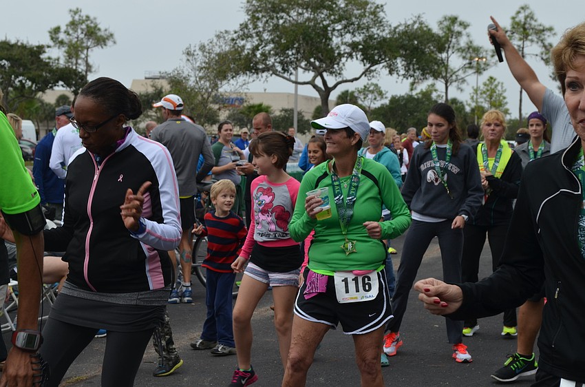 Peg Suel enjoys a well-deserved drink and dance after the race.