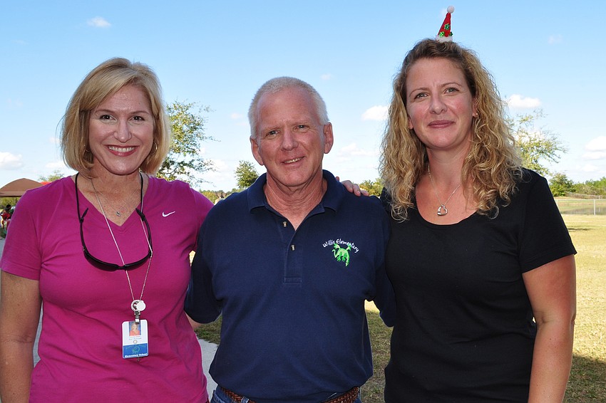 Assistant Principal Connie Dixon, Principal Bill Stenger and event organizer Liz Combe greet guests.