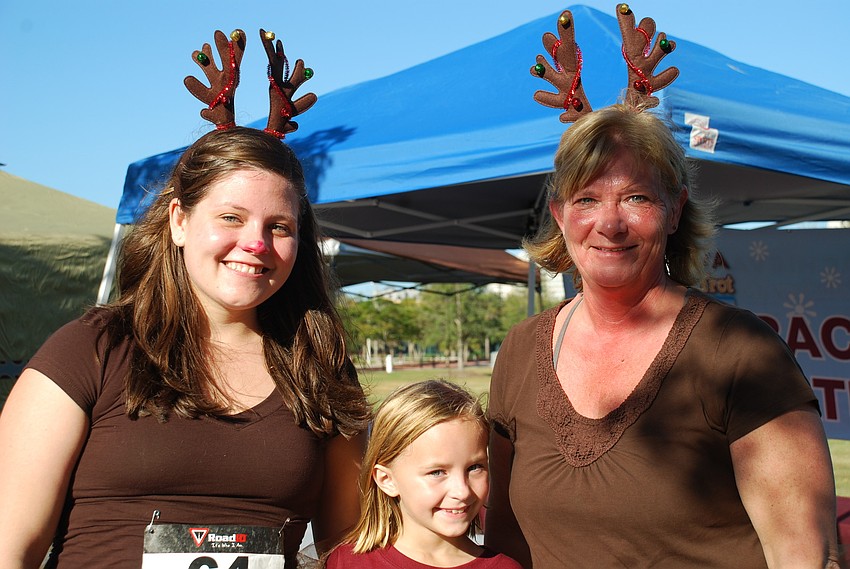 Erin White, Anna Ourrednik and Jan White dressed as reindeer for the 5K run