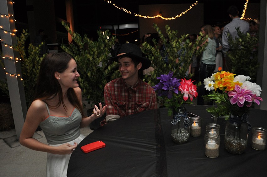 Hanna Kirchen and Matt Kennedy talk at a quieter spot outside the dance area.