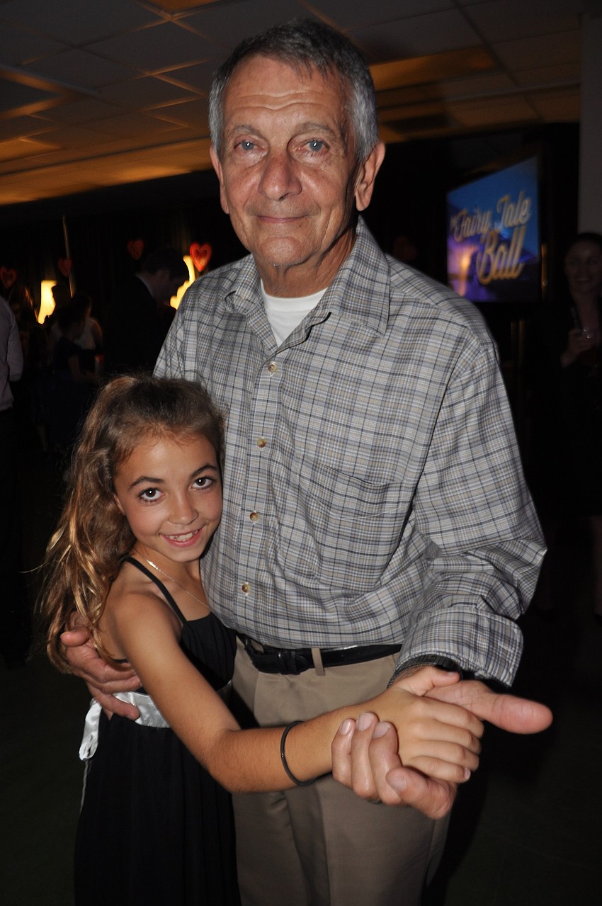 Josie Kolbe cuddles up with her grandfather, Joe Kolbe, at Braden River's dance.