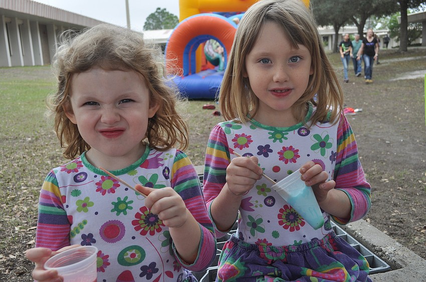 Sisters Madeline and Sophie Egan spooned snow cones.