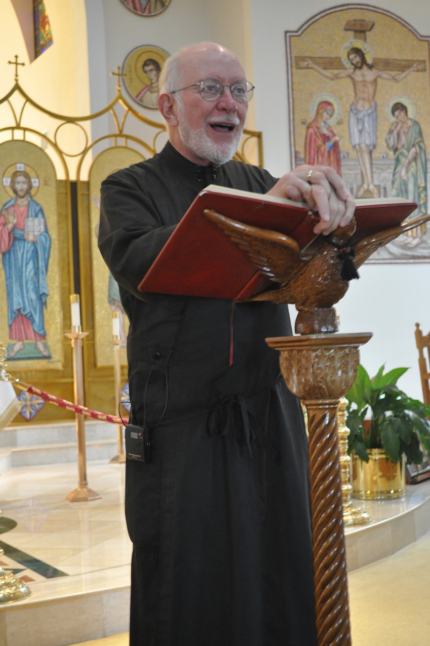 Visiting pastor Father Andrew explained the churchâ€™s history to visitors.