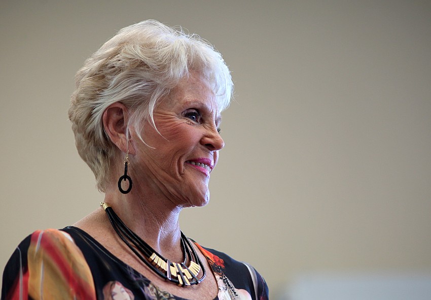 Kay Glass smiles at the crowd while modeling her Patchington outfit.