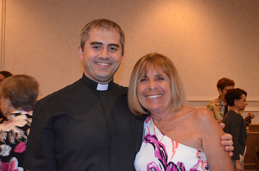 President of the Womenâ€™s Club Judith Treloar with Rev. Michael Szydzka.