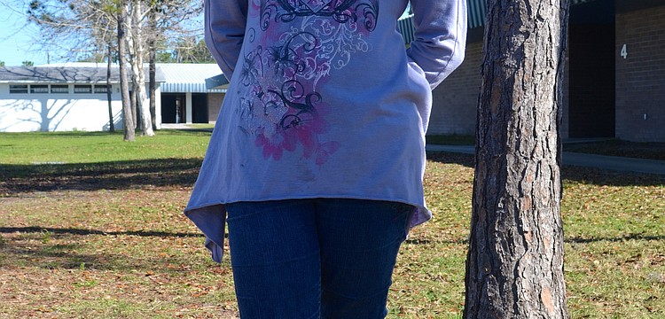 Anyssia Cotto, 10, says "cheese" in the shade.