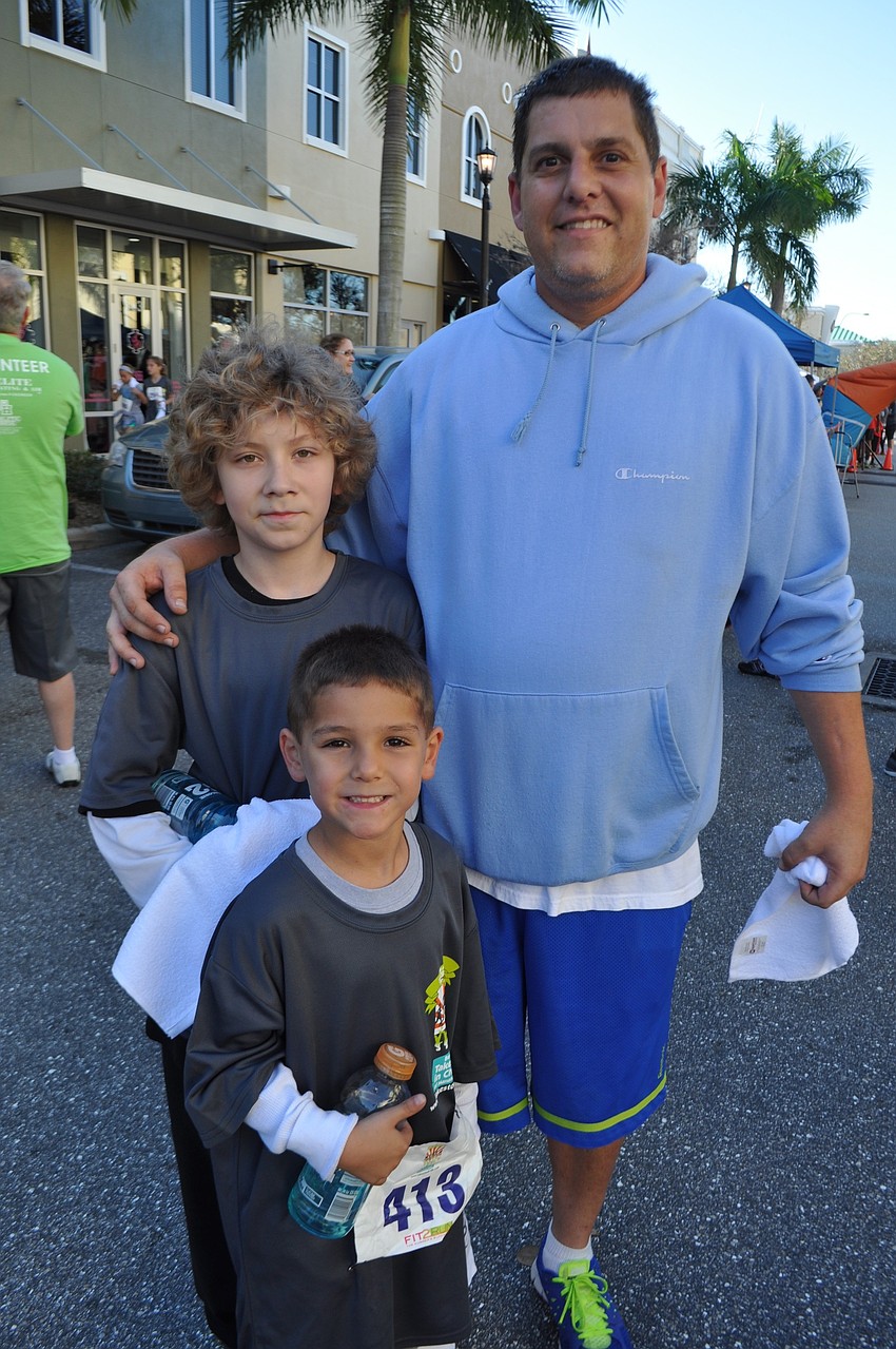 Jordan Jones, front, runs with his cousin, Sasha Perez, and dad, Jeffrey Jones, of Parrish.