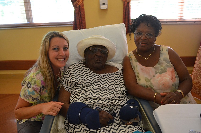 Nurse Sarah Cyphers with Ivy Reid, 101, and daughter Veronica Pierre
