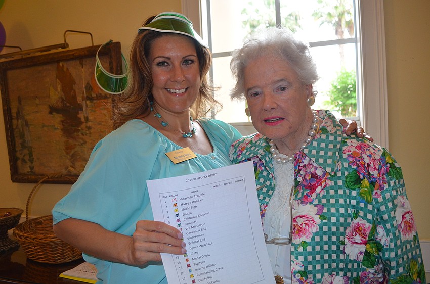Michelle Mols and Carol Davenport with a score sheet.