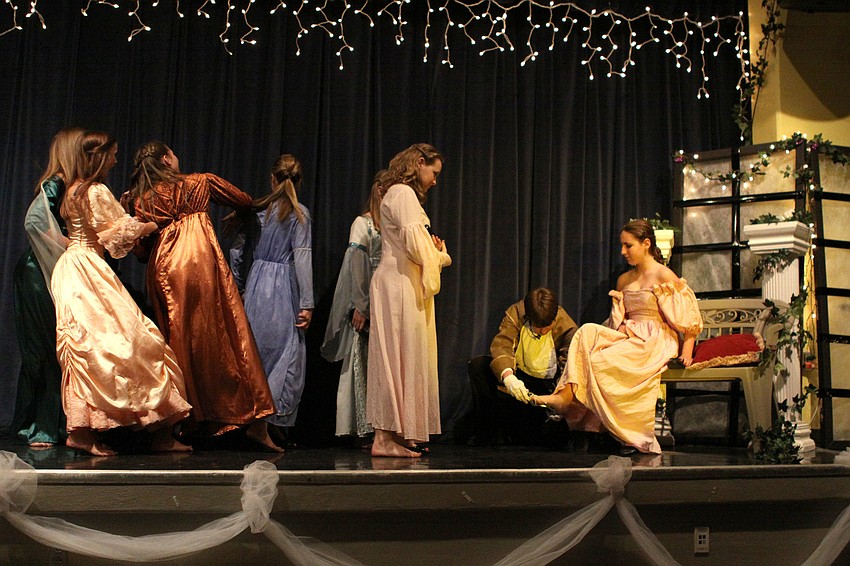 The Herald, Jackson Helwege, tries the glass slipper on the women in the kingdom.