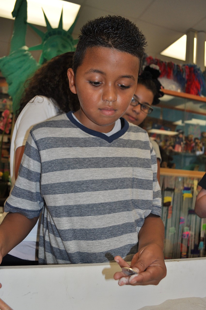 Josue Nunez, 9, found a foreign coin.