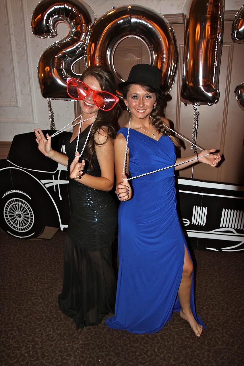 Sisters Marissa and Brianna Butler have some fun with the props at Sarasota Military Academyâ€™s Prom Saturday night at Michaelâ€™s On East.