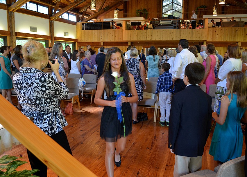 Sydney takes her seat before graduation.