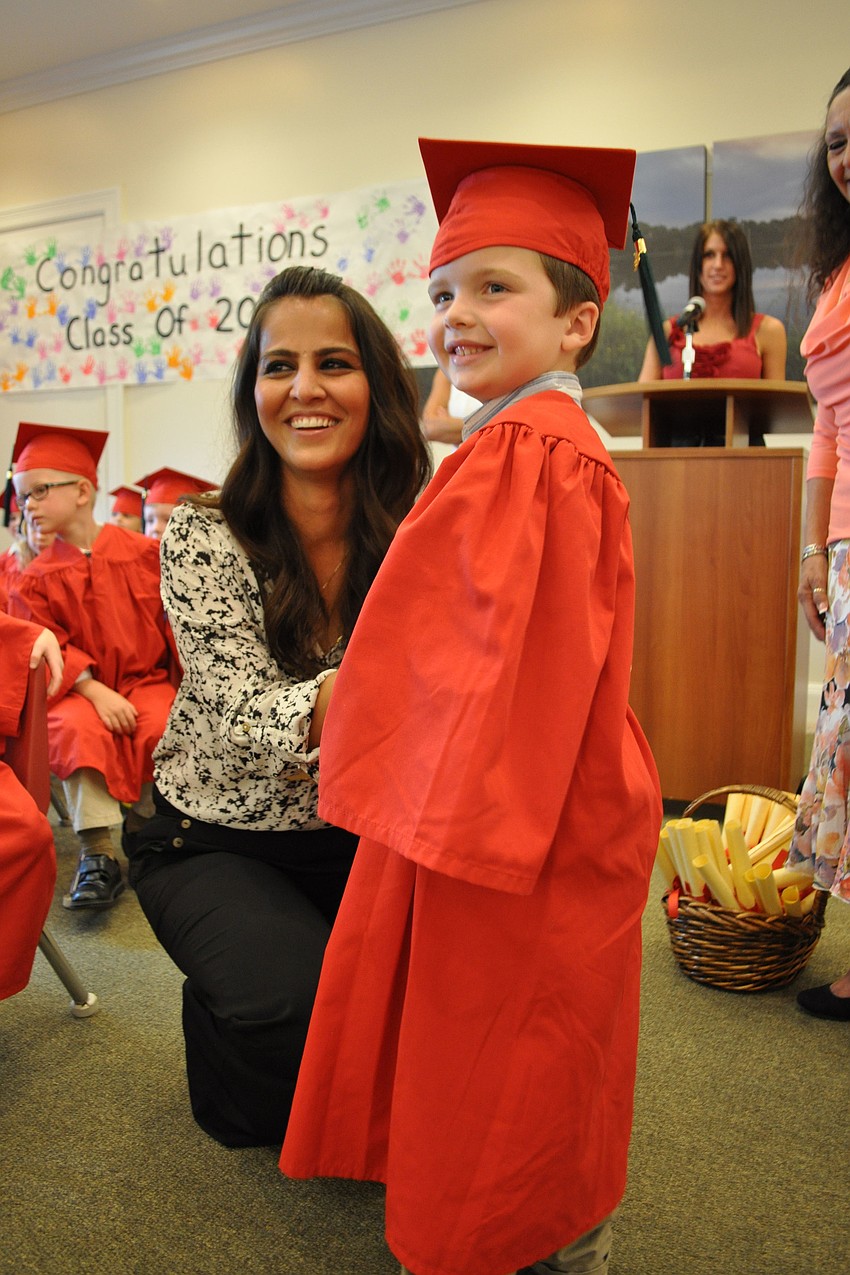 Primrose teacher Shagolfa Hassanzadeh gives Stephen Gross his diploma.