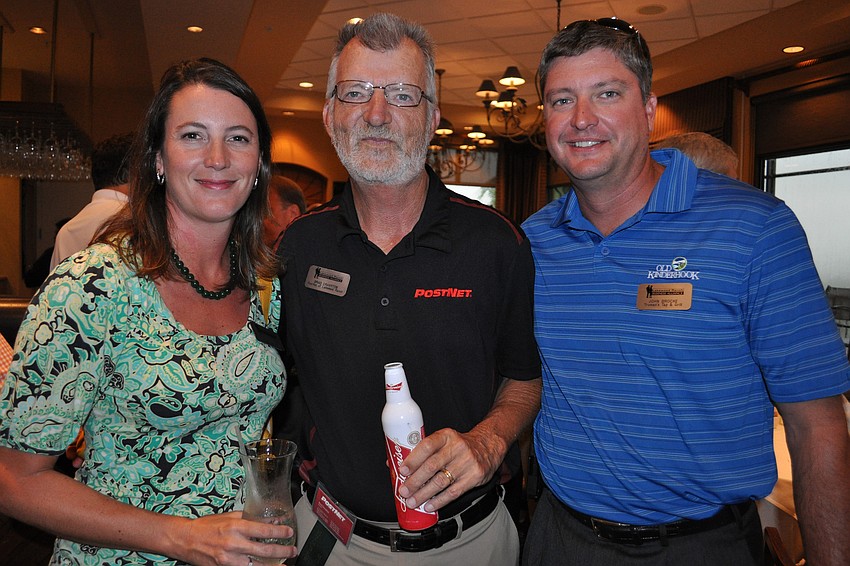 Tara Brocke, of Trumanâ€™s Tap and Grill,  with Brad Cranston, of PostNet, and John Brocke, also of Trumanâ€™s Tap and Grill
