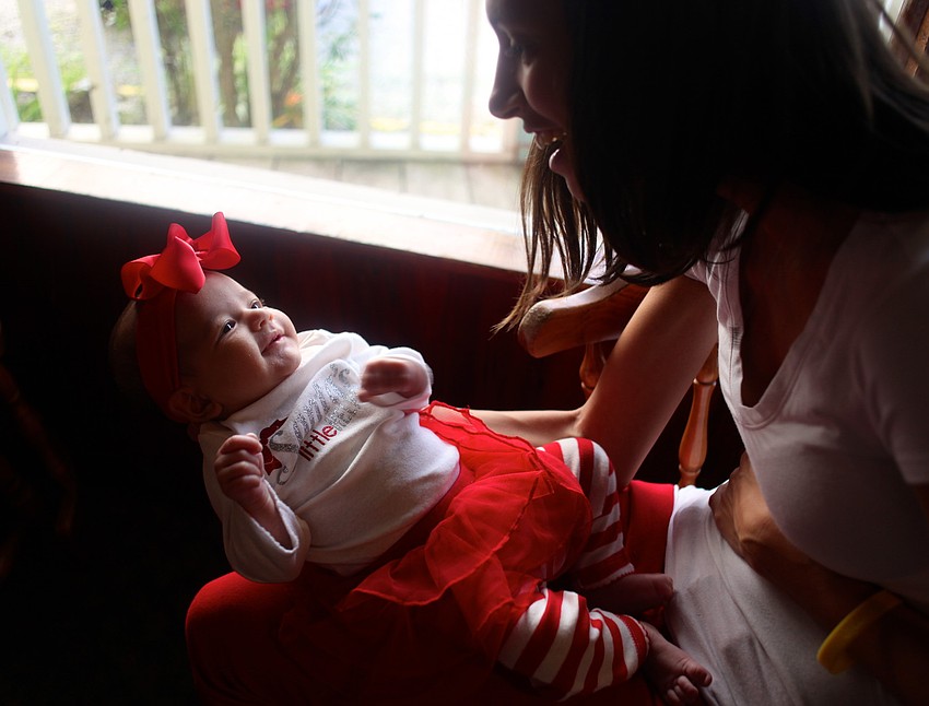 Whitney Gregory holds her two-month-old daughter, Sienna.