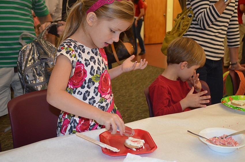 Maggie Yull decorates her Christmas cookie.
