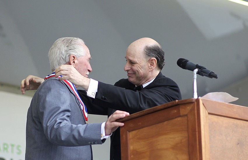 Inductee Ian Garden Sr. receives his Ring of Fame medal from Chuck Sidlow.
