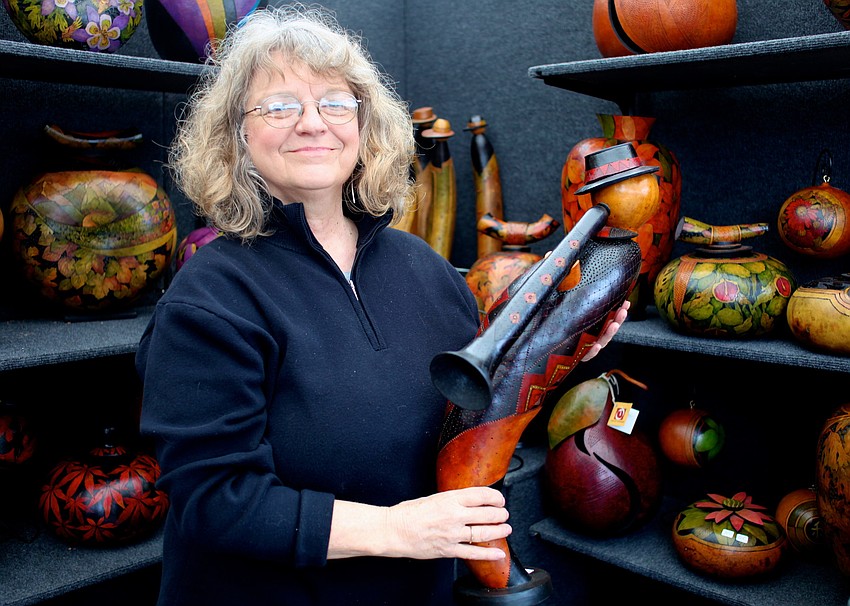 Beth Radtke holds one of her handcrafted gourd vessels.