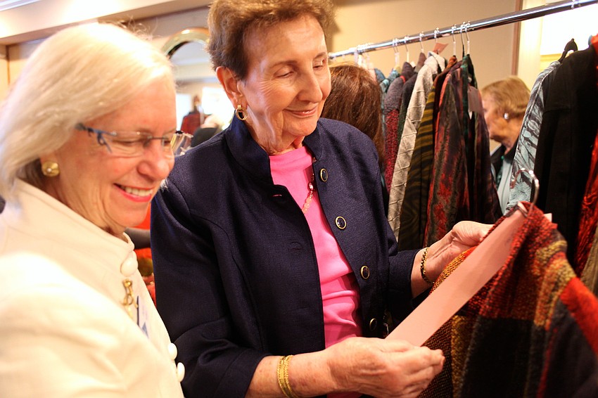 Daphne Walker and Dorothy Cole look at McGeeâ€™s collection after the show.