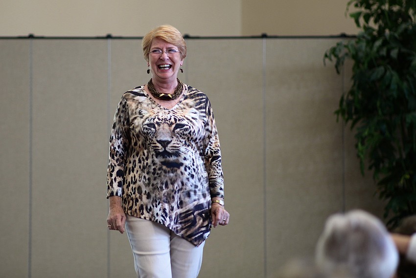 Judith Neale laughs as she models an animal-print tunic.