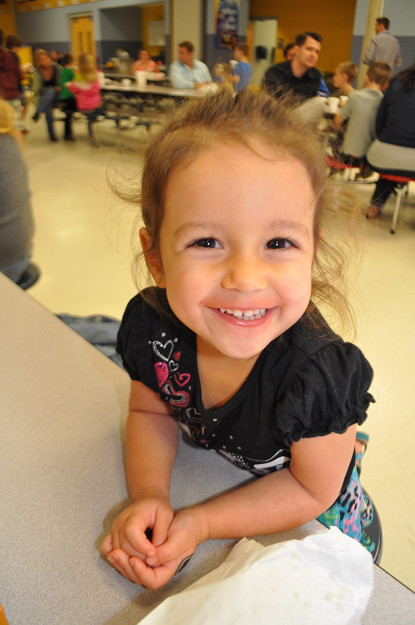 Layla Bennett, 2, is all smiles as she digs into her ice cream.