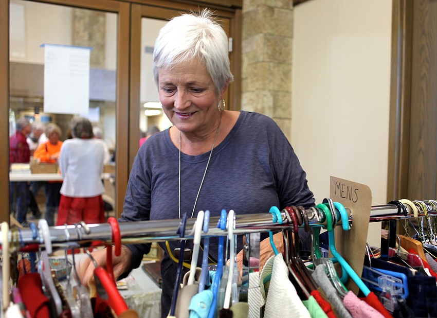 Pam DeFratus looks at the womenâ€™s clothing in the boutique section of the sale.