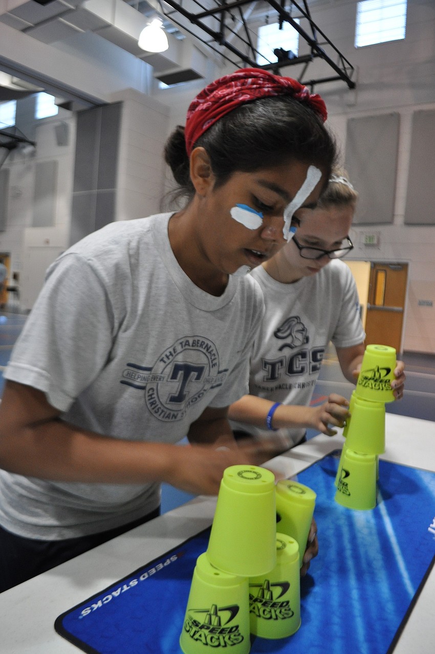 Vanessa Viera, 11, stacks cups.
