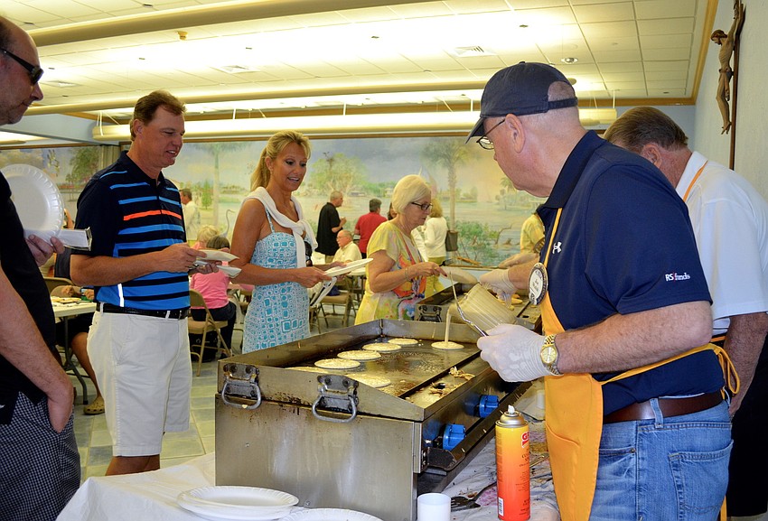 Attendees wait for fresh pancakes.