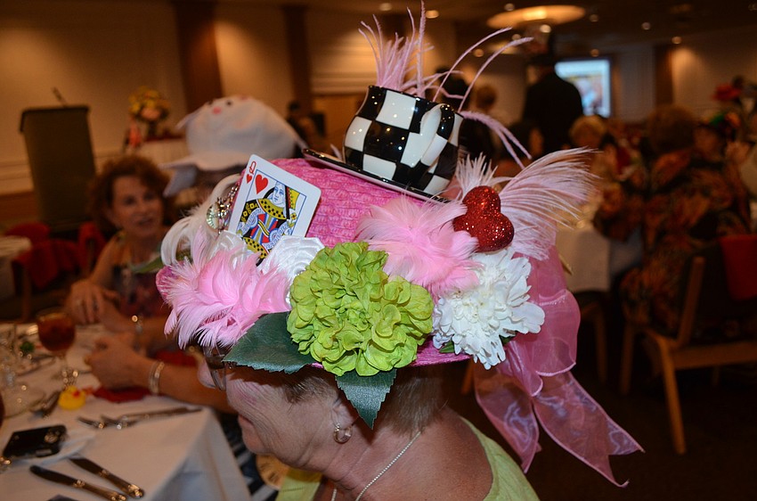Nancy Augsburgerâ€™s hat includes a tea-cup and queen of hearts card.