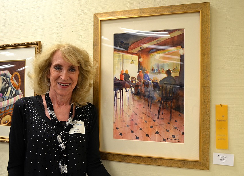 Elaine Charney poses with her painting, â€œBar Scene,â€ which won an honorable mention.