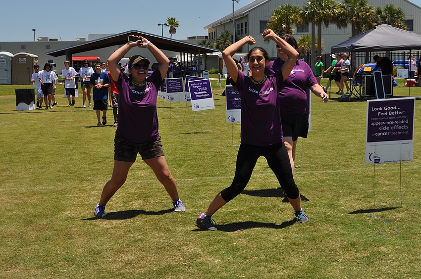 Alex Hernandez and Inita Bedi, of Team Cancer Crushers, add a fitness challenge to each of the laps they walk.