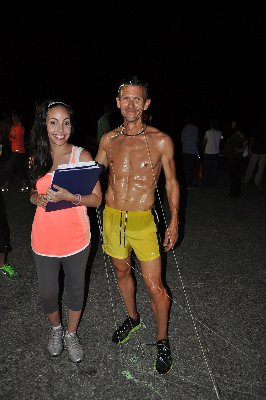 Alene Fowler with first-place finisher John Wood. Wood was sprayed with silly string after crossing the finish line.