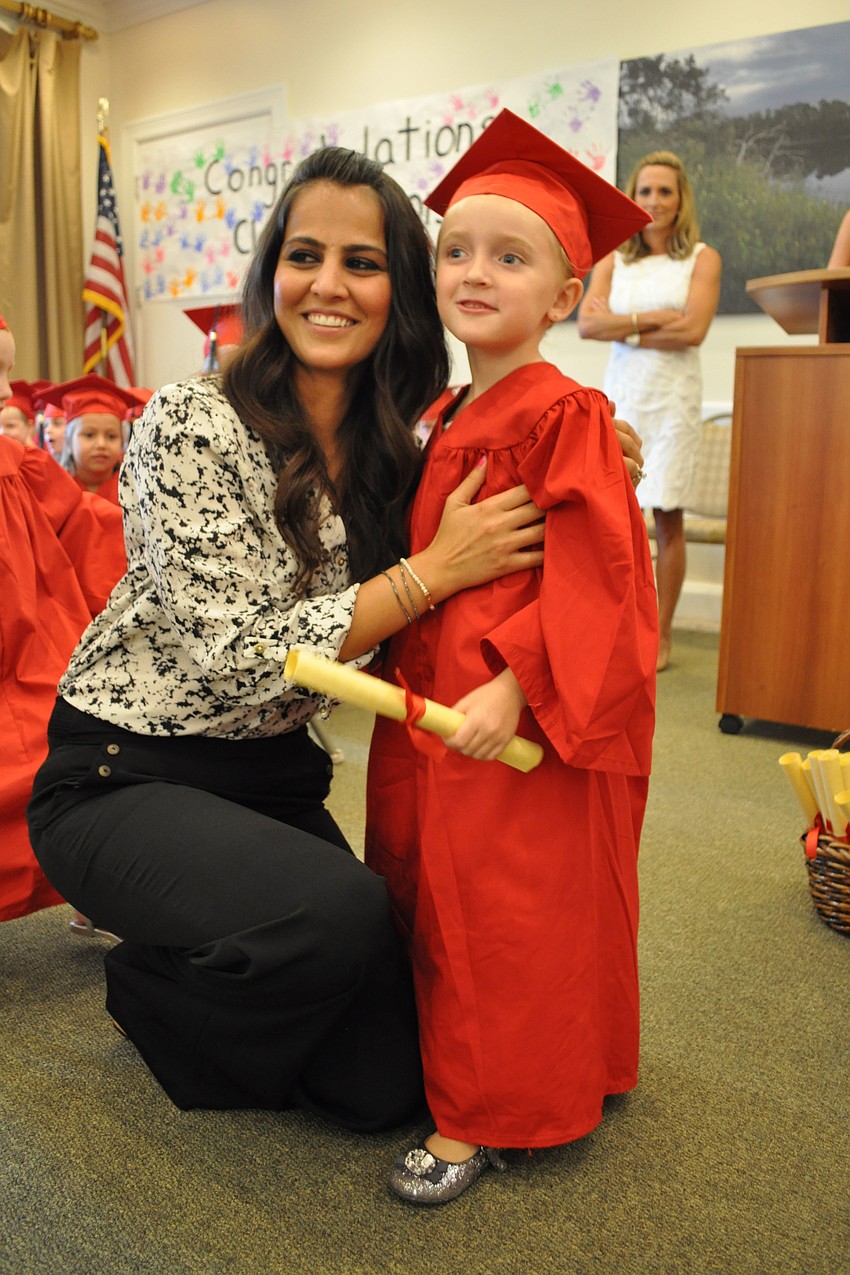 Shagolfa Hassanzadeh gives Nadia Grubbs her diploma.