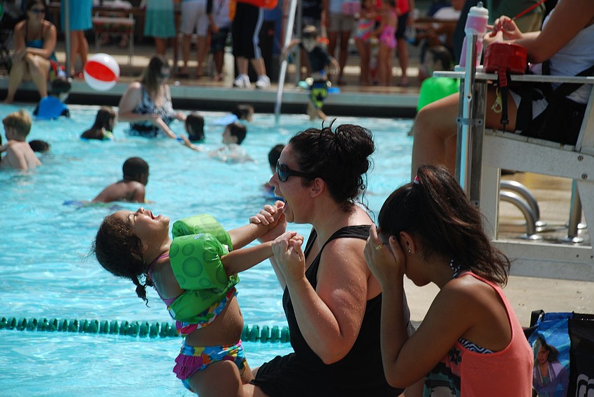 Jaelyn Dismuke, 2, and Joanna Carrier played on the side.
