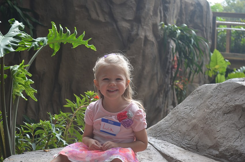 Lia Olenoski is all smiles as she sits by the water.