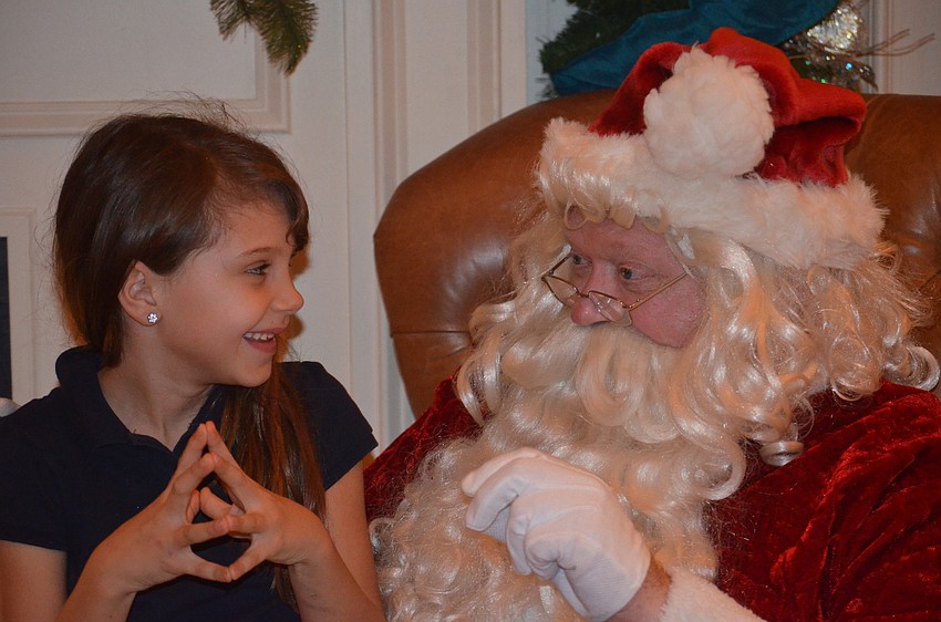 Sophia Miller tells Santa that she would like a pink purse for Christmas