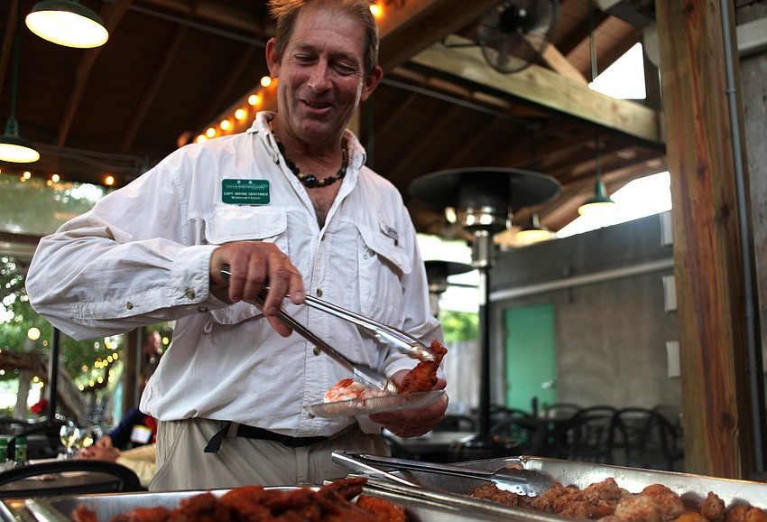 Captain Wayne Genthner, Wolfmouth Charters, visits the refreshments table.
