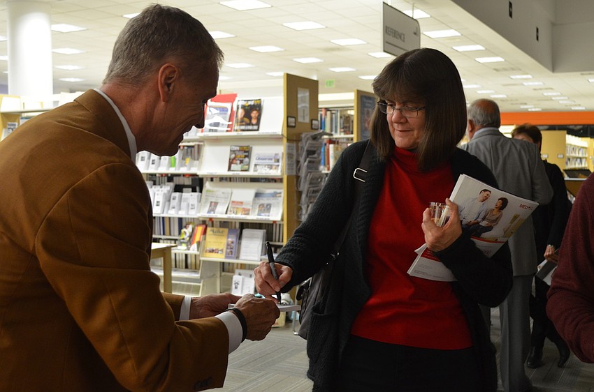 Magician Gary Roberts works his magic on Margie Mills.